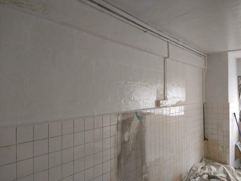 Asian Kitchen with Homogeneous Tiles and Cupboard