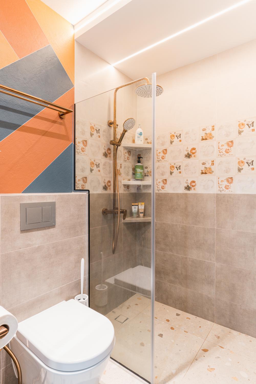 Eclectic Bathroom with Homogeneous Tiles and Shower Screen