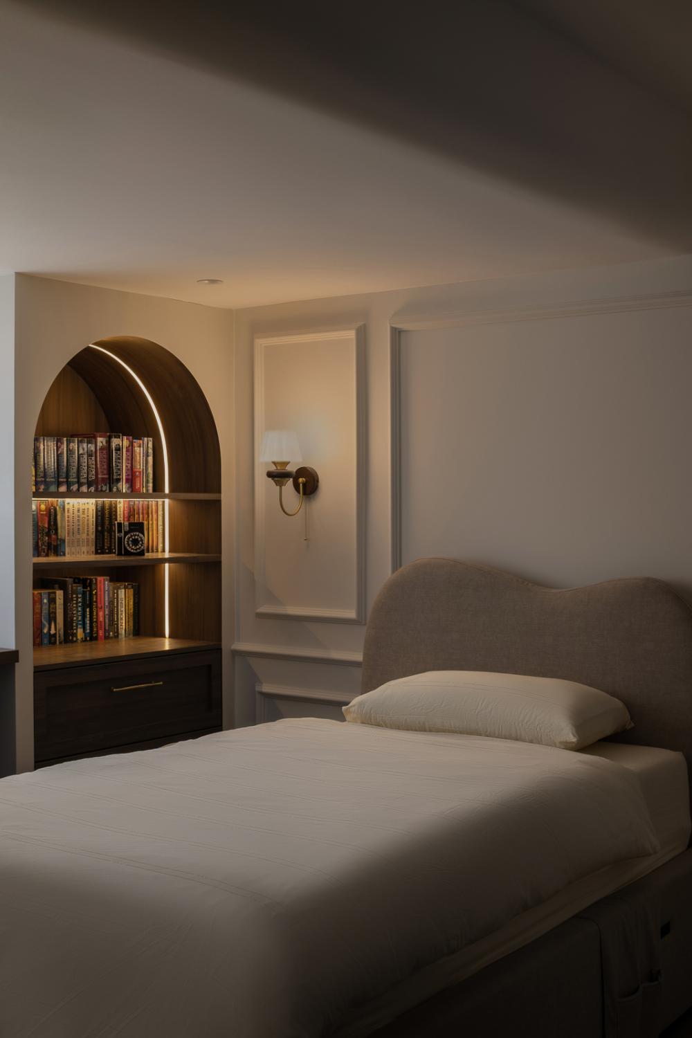 Modern Bedroom with Bookshelf and Cove Lighting