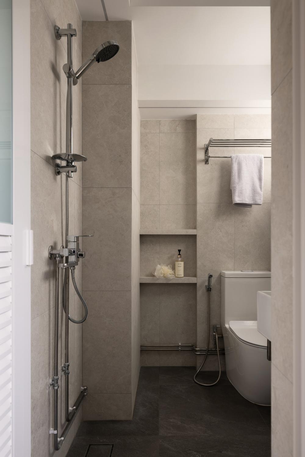 Minimalist Bathroom with Homogeneous Tiles and Showers
