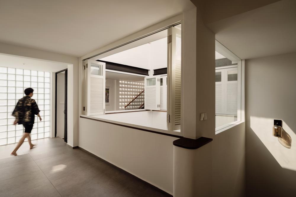Vintage Hallway with Homogeneous Tiles and Window Shutters