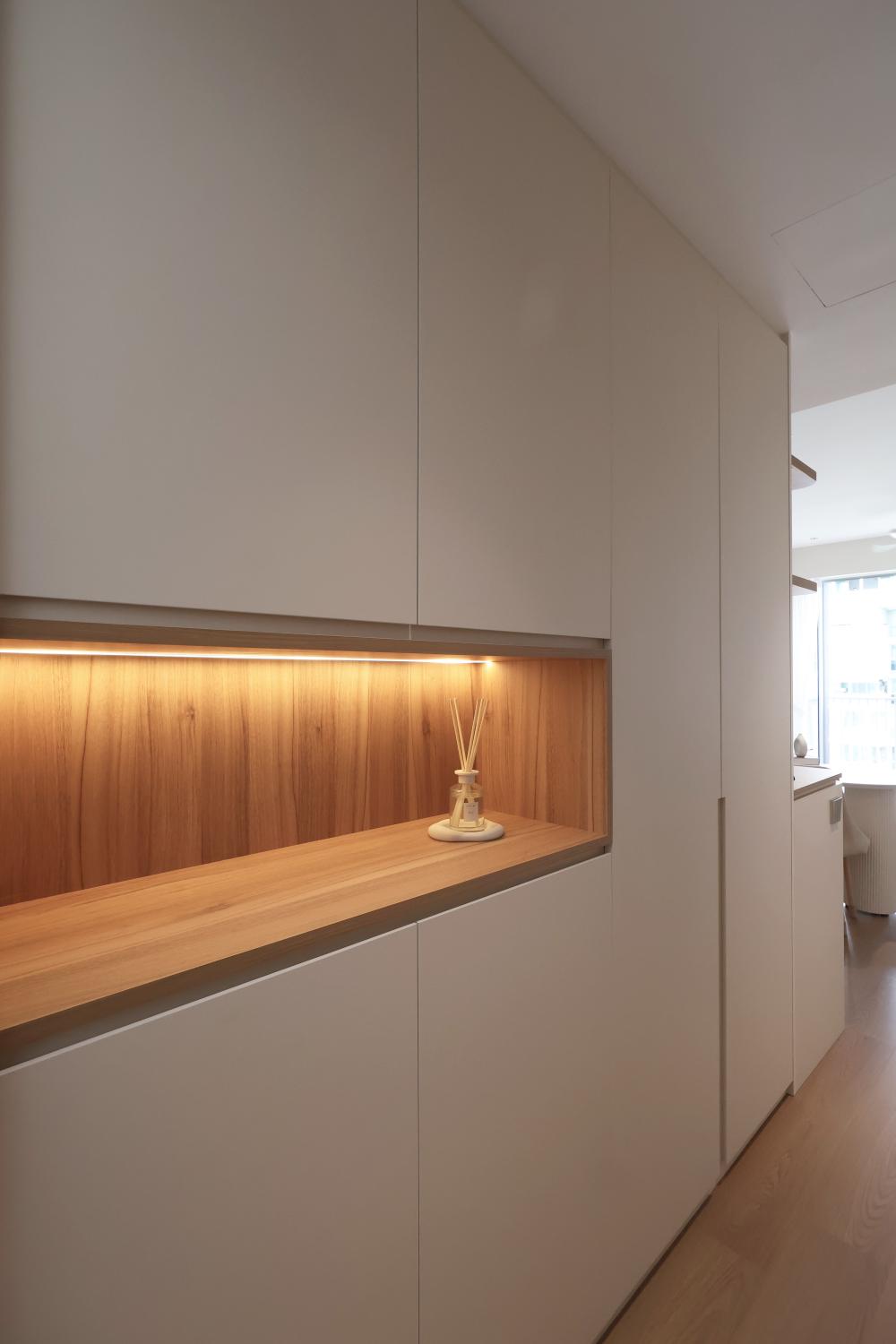 Minimalist Entryway with Paintings and Small Storage