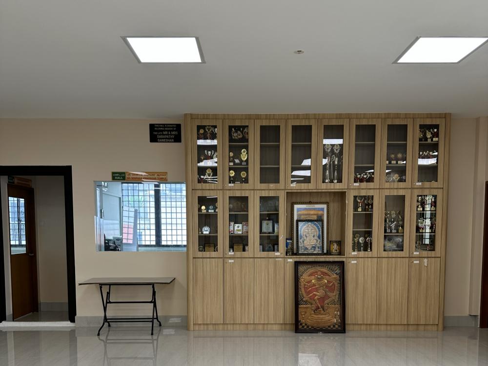 Transitional Home Office with Ceiling Light and Paintings
