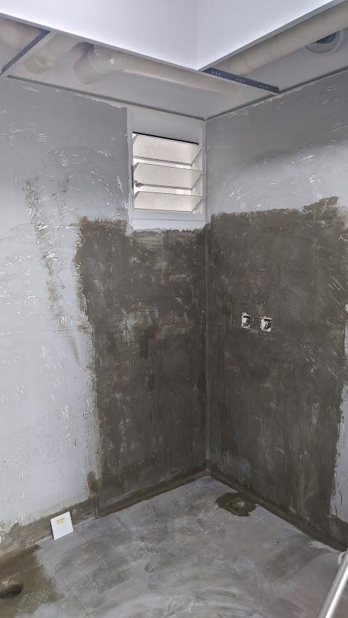 Asian Bathroom with Homogeneous Tiles and Mirror