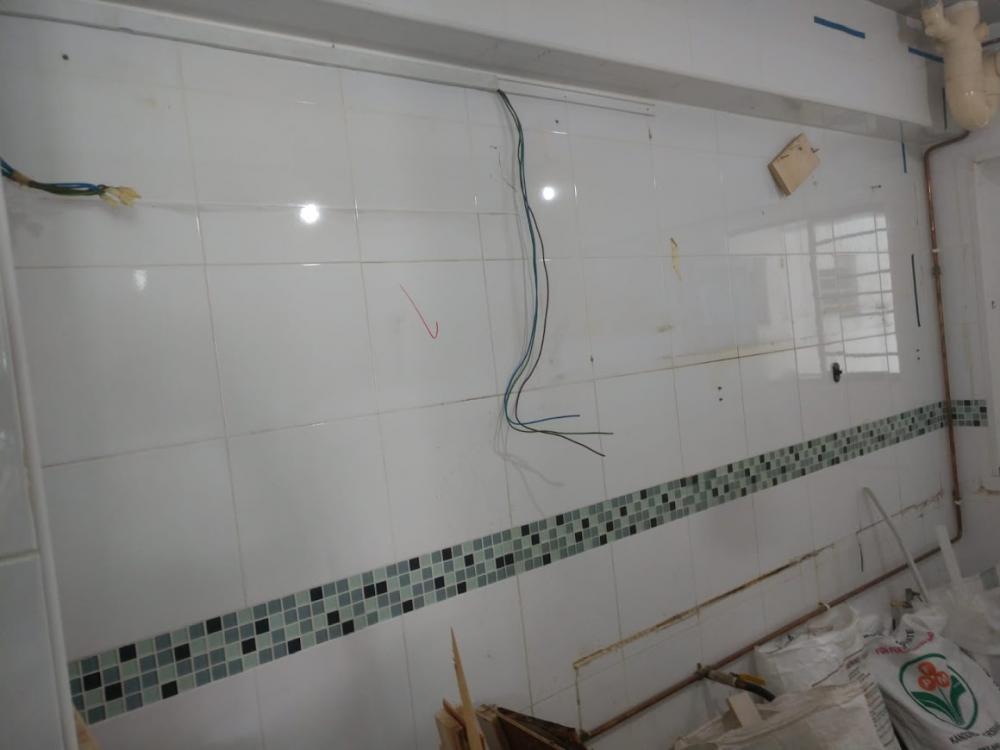 Asian Kitchen with Homogeneous Tiles and Wood Flooring