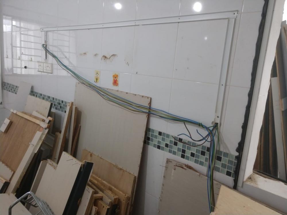 Asian Kitchen with Homogeneous Tiles and Cupboard
