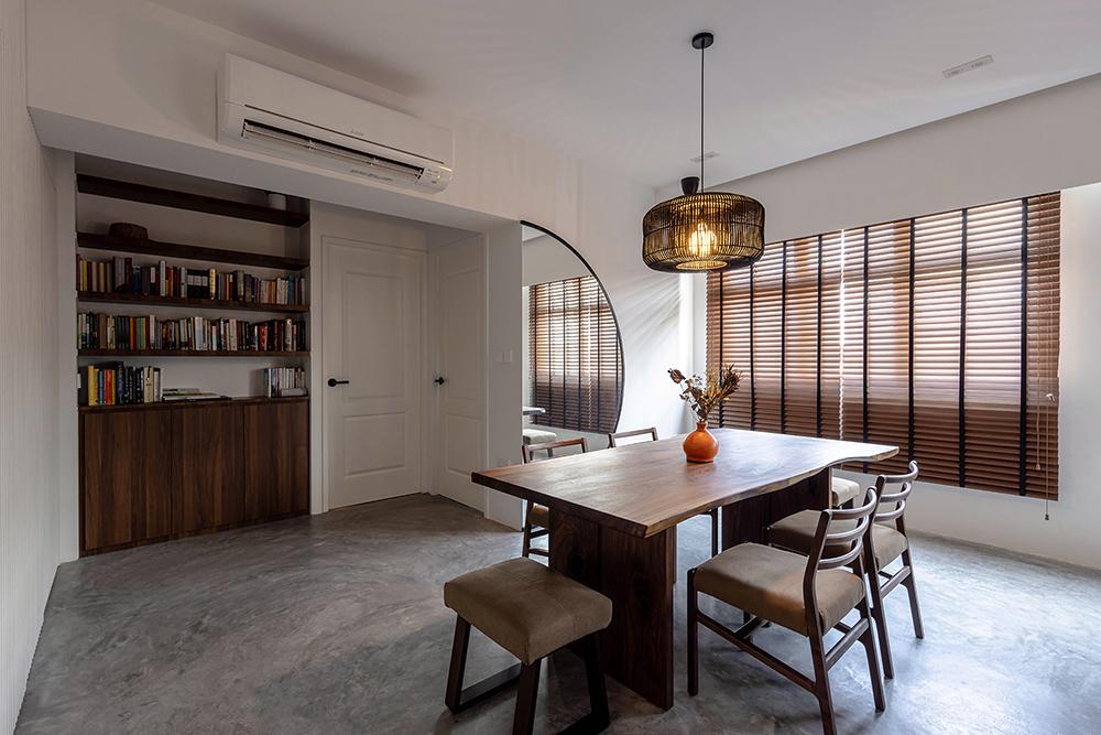 Scandinavian Dining Room with Bookshelf and Cement Floor