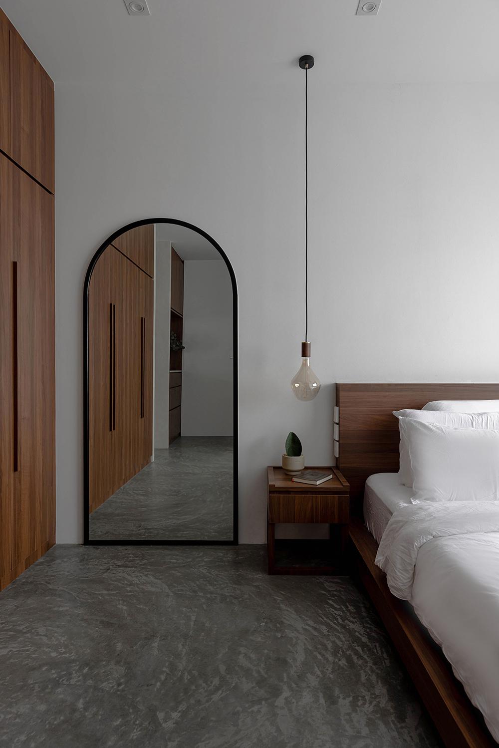 Scandinavian Bedroom with Cement Floor and Mirror