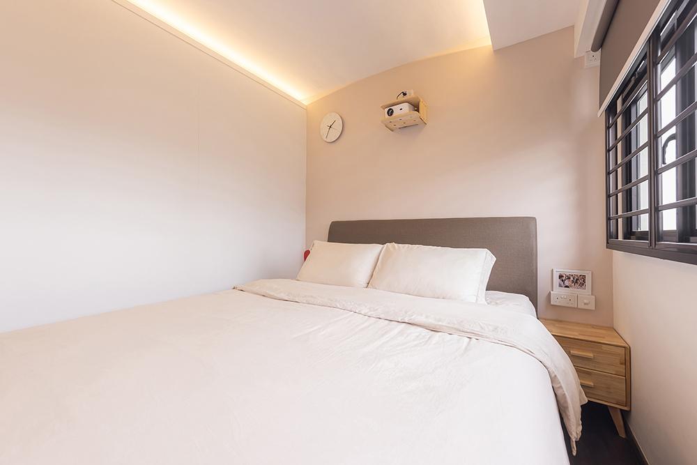 Industrial Bedroom with Cove Lighting and Paintings