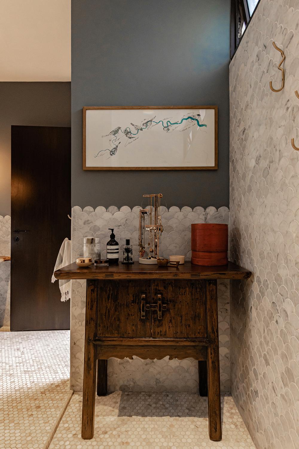 Eclectic Bathroom with Marble Floor and Artwork