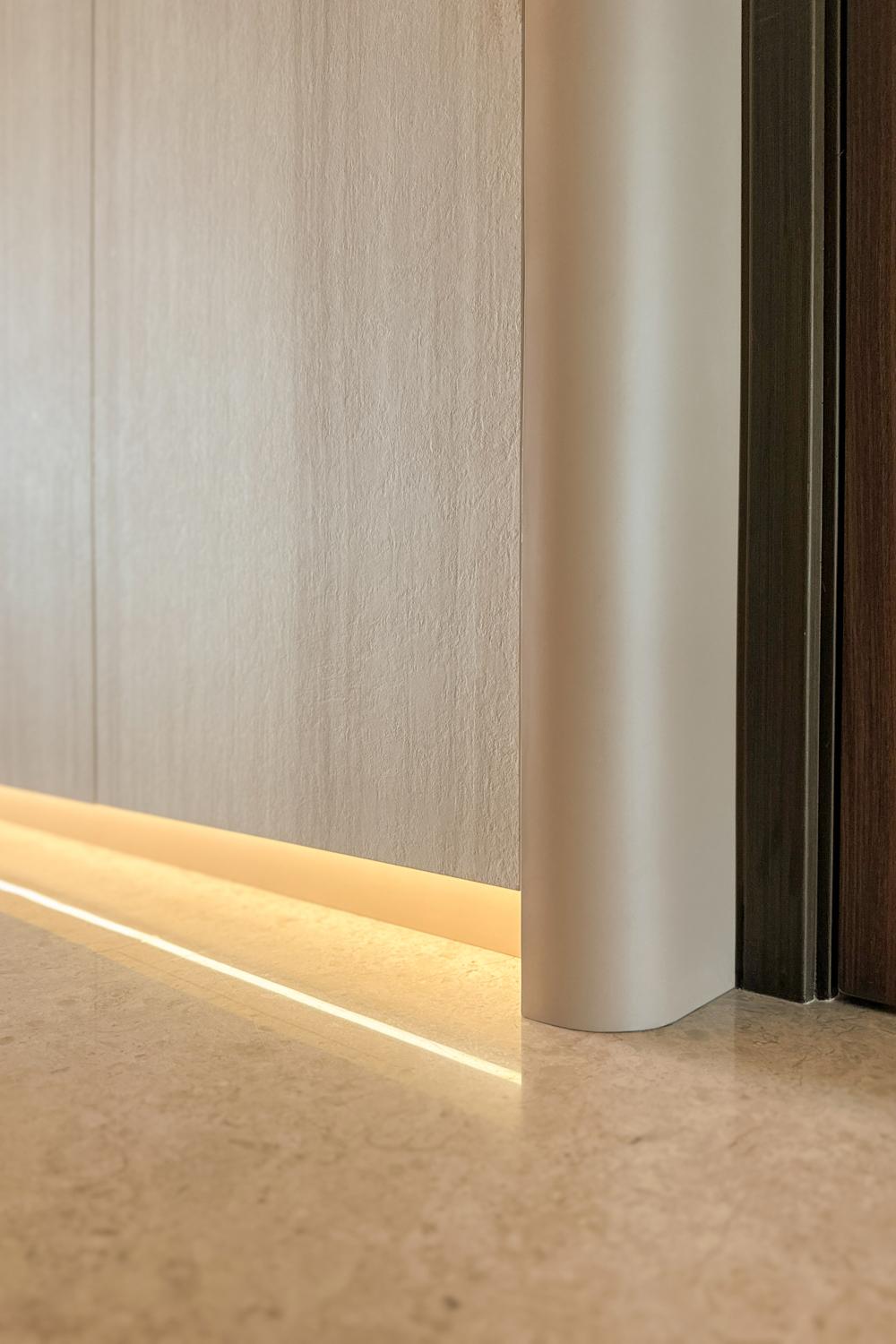 Modern Foyer with Cove Lighting and Storage Cabinets