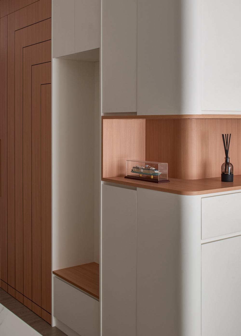 Minimalist Foyer with Feature Wall and Storage Cabinets