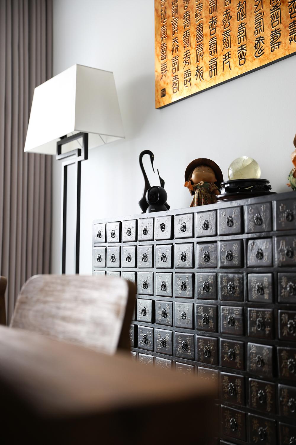 Asian Dining Room with Artwork and Storage Cabinets
