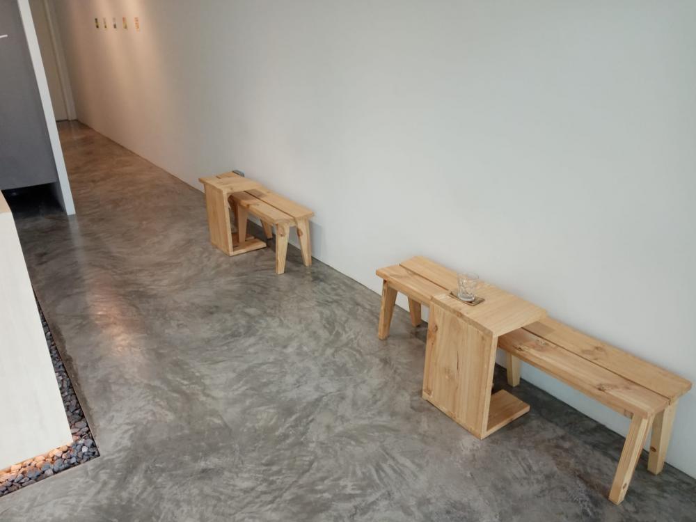 Minimalist Retail with Cement Floor and Seating Bench