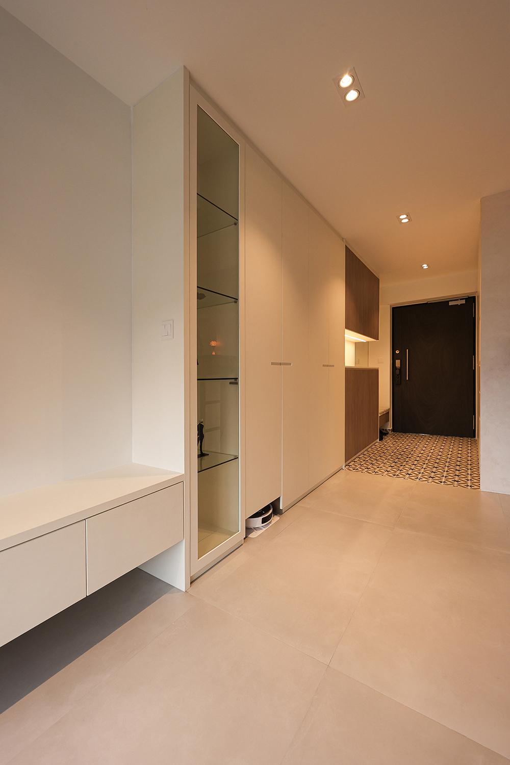 Minimalist Foyer with Homogeneous Tiles and Storage Cabinets