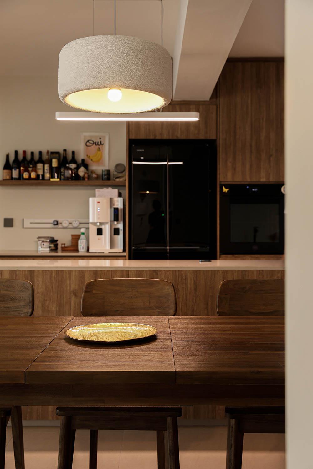 Minimalist Dining Room with Open Kitchen and Storage Cabinets