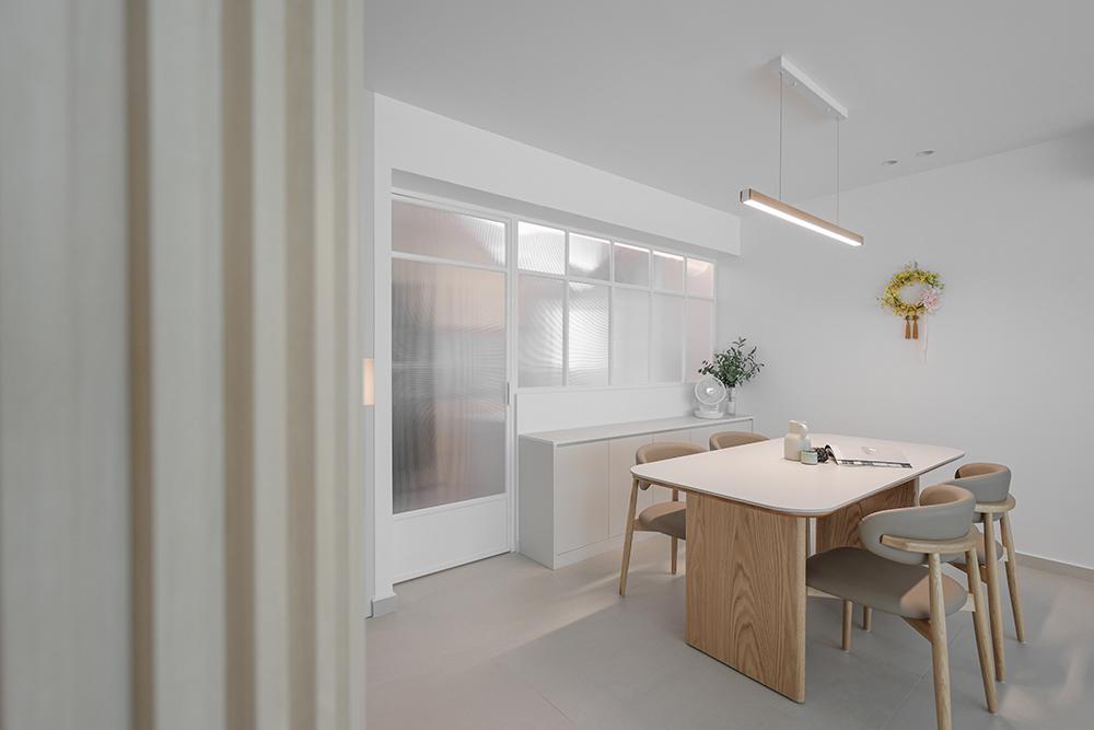 Minimalist Dining Room with Homogeneous Tiles and Glass Door