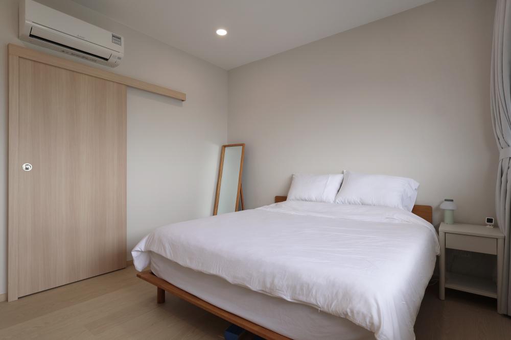 Minimalist Bedroom with Vinyl Flooring and Ceiling Light