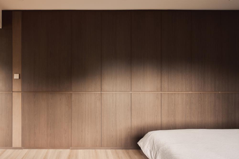 Contemporary Bedroom with Wood Flooring and Feature Wall