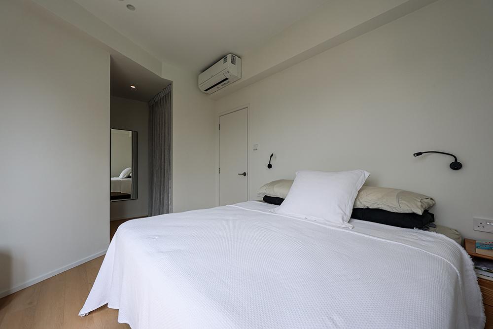 Country Bedroom with Wood Flooring and Paintings