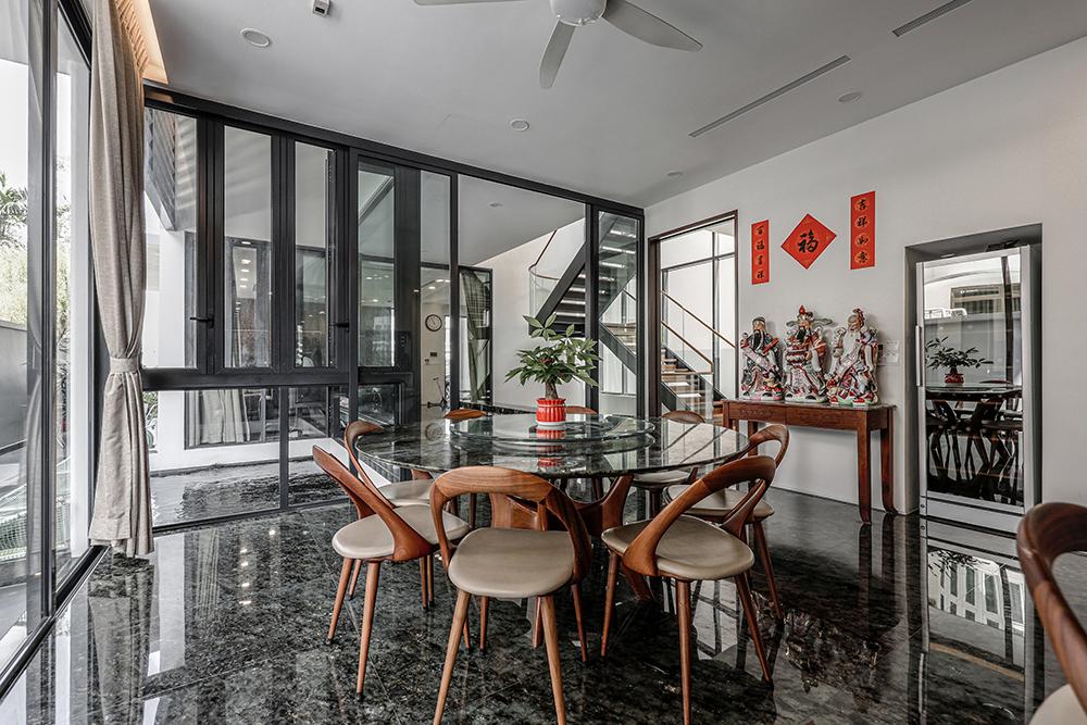Modern Dining Room with Granite Floor and Glass Door