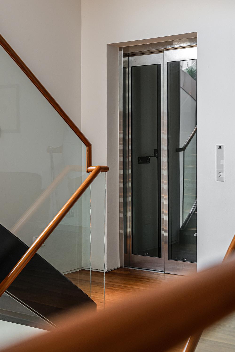Modern Hallway with Staircase and Paintings