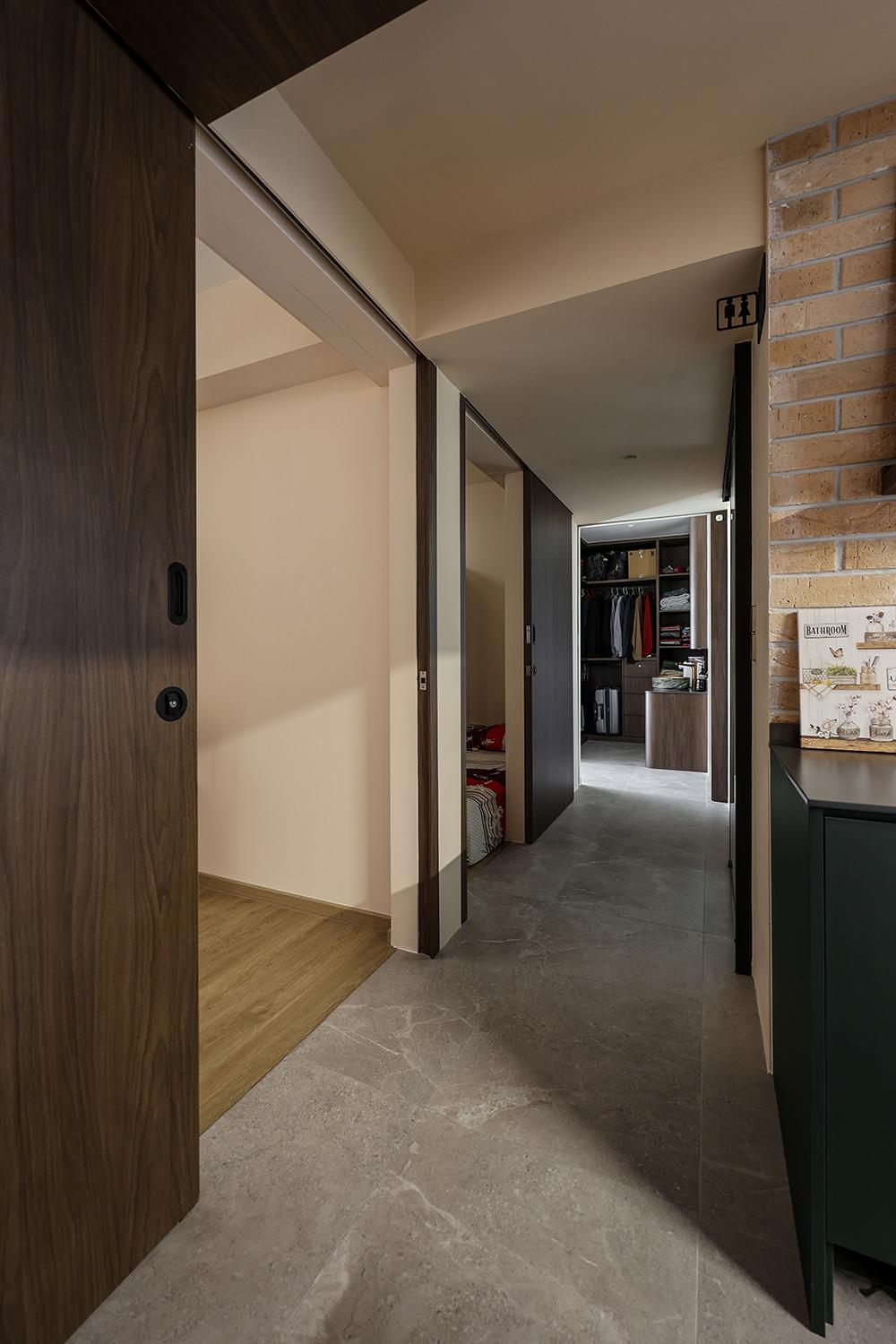 Eclectic Hallway with Homogeneous Tiles and Doors