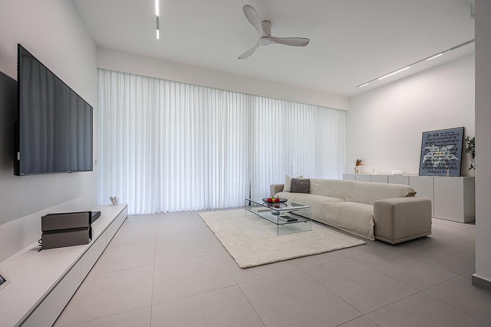 Minimalist Living Room with Homogeneous Tiles and TV Console