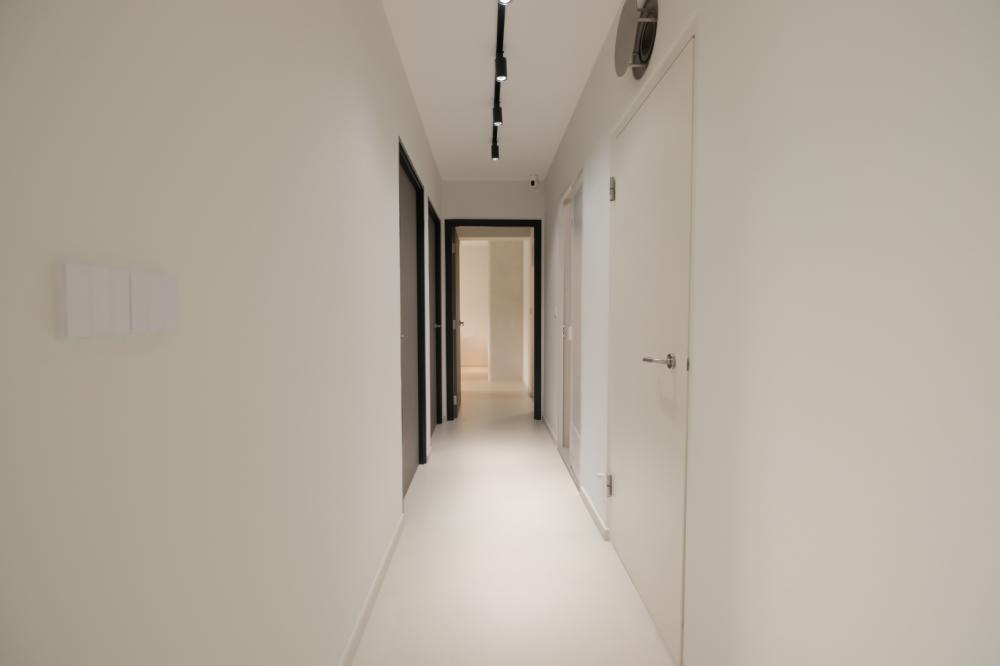 Minimalist Hallway with Bookshelf and Artwork