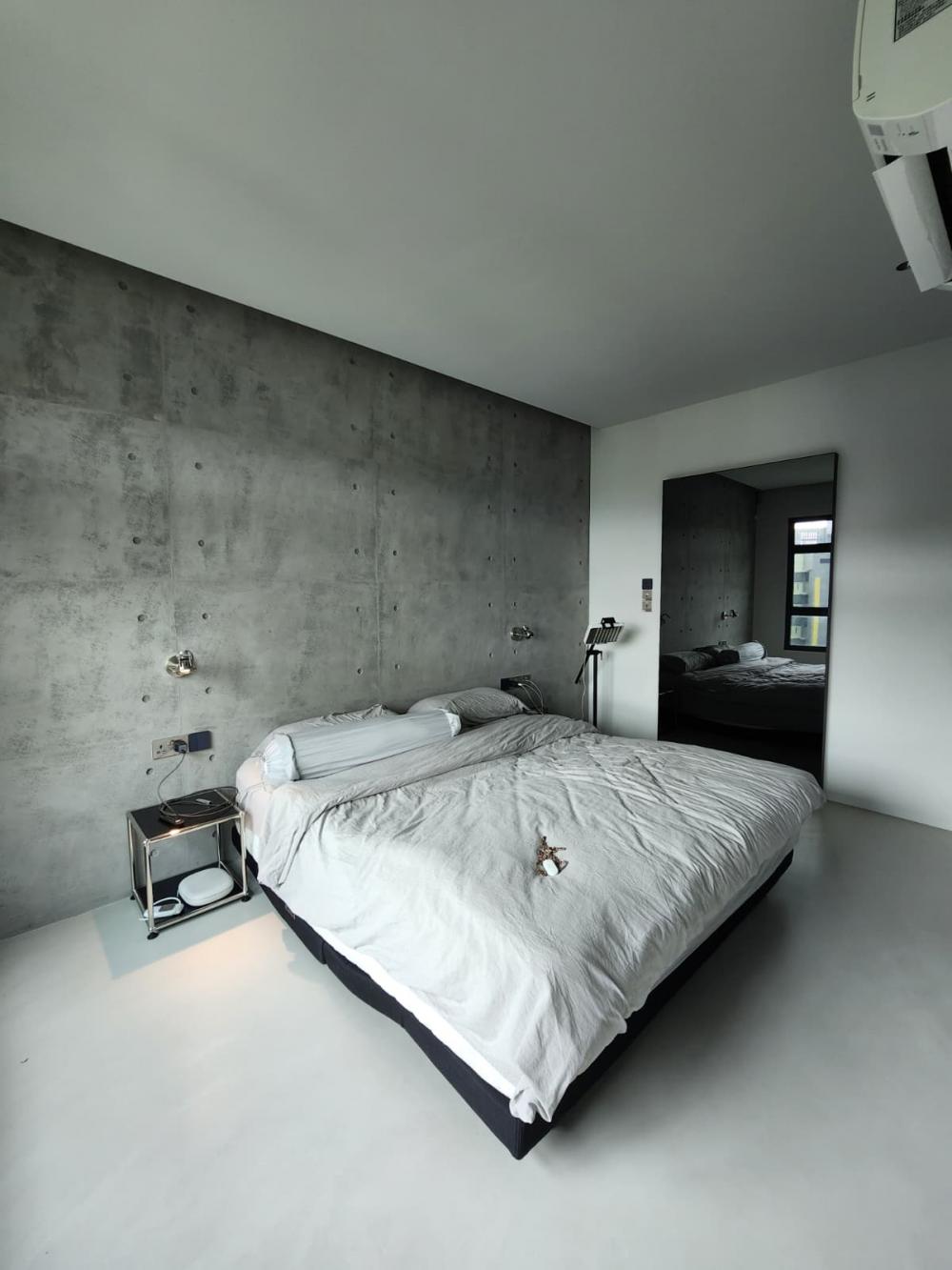 Industrial Bedroom with Cement Floor and Feature Wall
