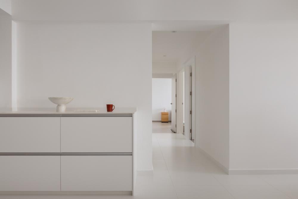 Minimalist Hallway with Homogeneous Tiles and Storage Cabinets