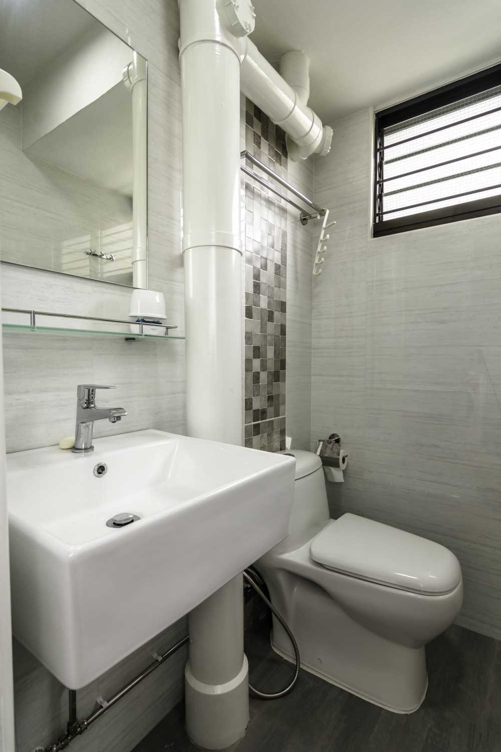 Industrial Bathroom with Homogeneous Tiles and Mirror