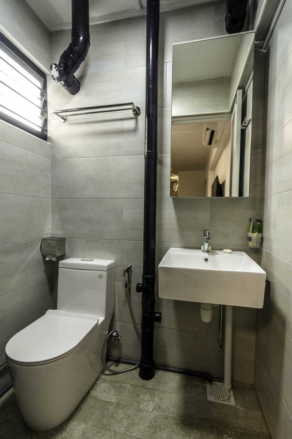 Industrial Bathroom with Homogeneous Tiles and Mirror